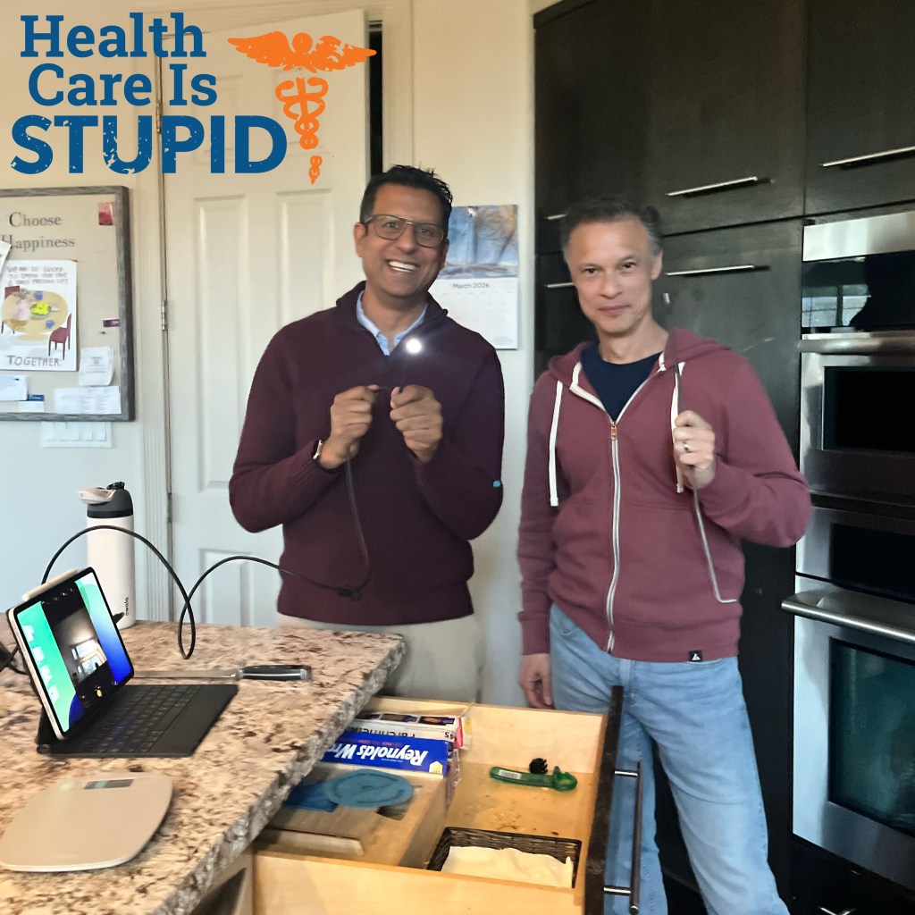 Hosts holding up their disimpaction equipment in front of the freed kitchen drawer